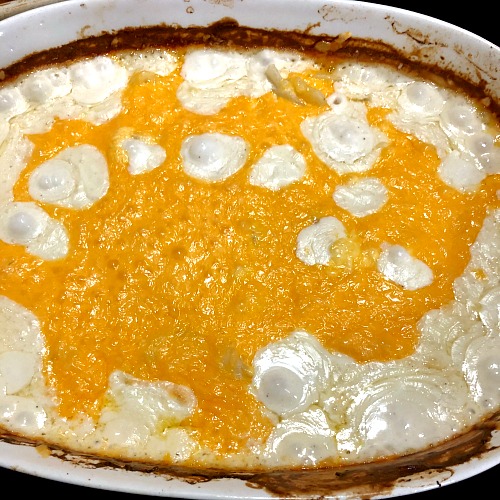 photo of baked scalloped potatoes with melted cheddar cheese on top