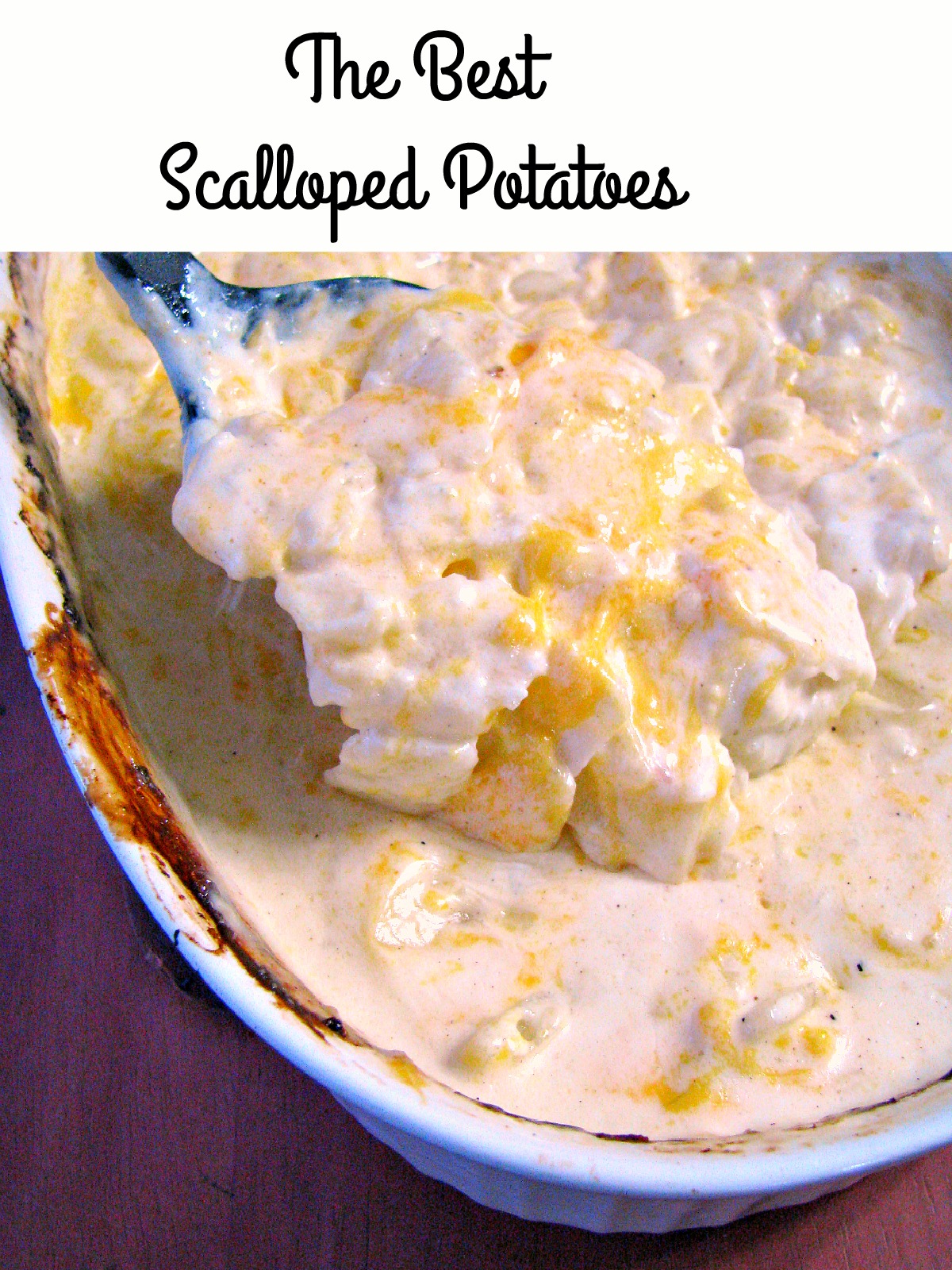 photo of baked scalloped potatoes in a baking dish with a spoon lifting the potatoes