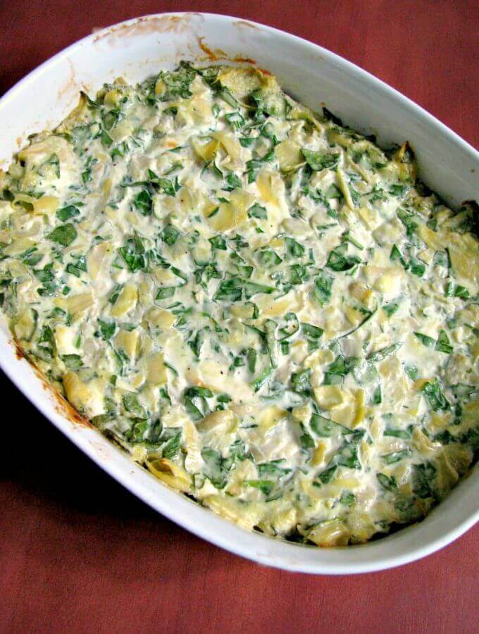Spinach Artichoke Dip, made with fresh or frozen spinach, canned artichokes, cream cheese, and Gouda cheese, then baked or cooked in the slow cooker.