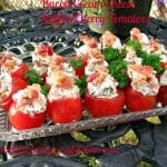 Photo of Bacon Cream Cheese Stuffed Cherry Tomatoes in a glass plate on a rod iron table