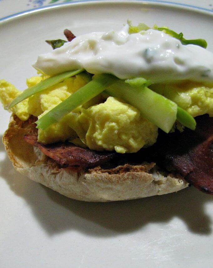 This Light Eggs Benedict recipe is made lighter by using egg whites instead of whole eggs, light English muffins, turkey bacon, and topped with shaved asparagus and a much lighter version of Hollandaise sauce.