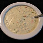 Photo of Crab Bisque in a white bowl on a black tablecloth