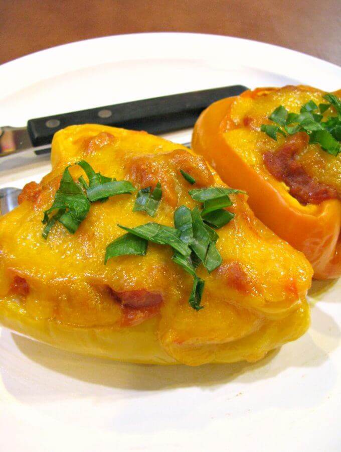 Cheesy, flavorful, and healthy Sloppy Joe Stuffed Peppers! These stuffed peppers are filled with ground chicken, traditional Sloppy Joe MANWICH sauce, pumpkin puree, carrots, celery, and Gouda cheese, then topped with cheddar cheese.