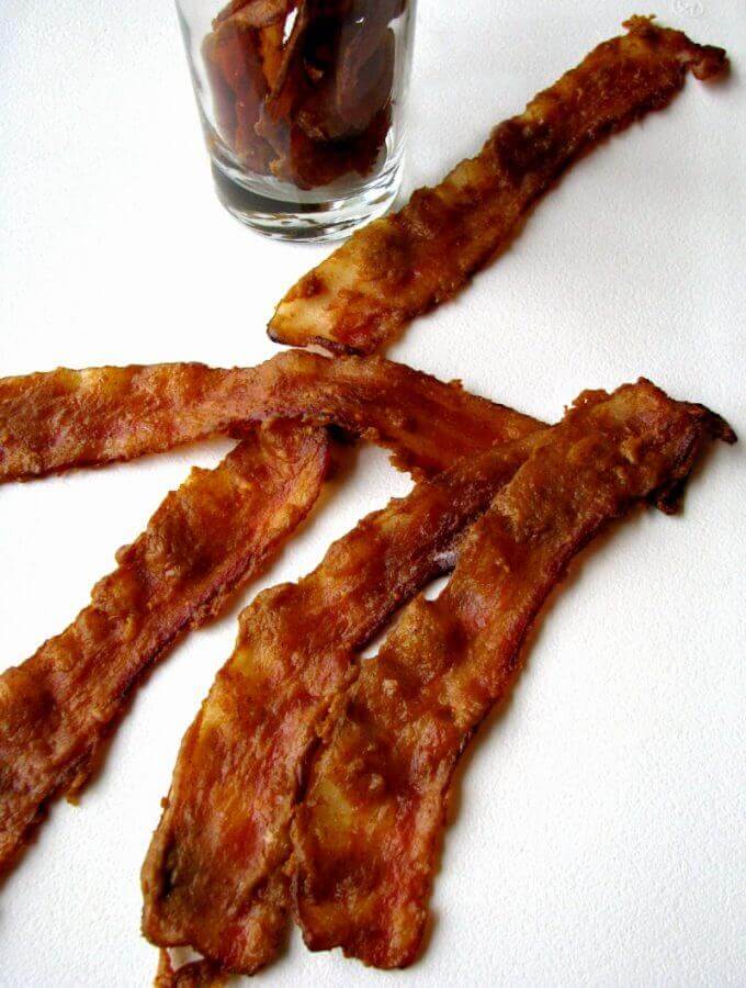 This seasonal Pumpkin Glazed Bacon is fabulous in a variety of dishes, or on it's own, and you only need 4 ingredients! It tastes like candied bacon, with a pumpkin kick!