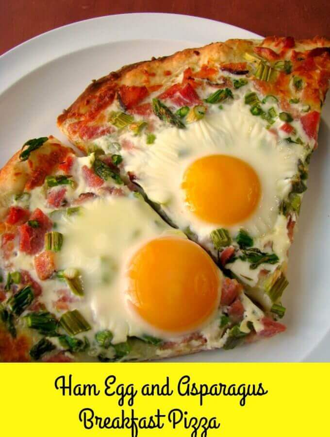Cheesy Ham Egg and Asparagus Breakfast Pizza made with a homemade pizza crust, diced ham, asparagus, and sunny-side up eggs, is perfect for brunch!