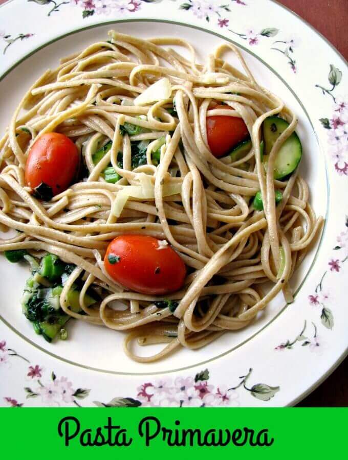 Light summertime vegetable Pasta Primavera, made with zucchini, spinach, asparagus, tomatoes, onions, and garlic, is a quick and easy dinner ready in less than 30 minutes.