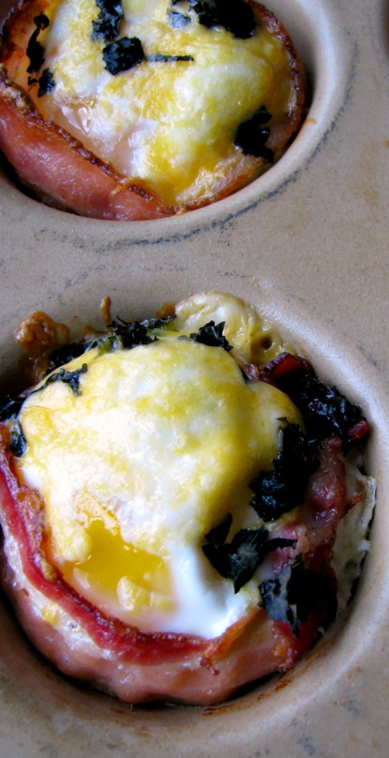 Sunny side up eggs in a bacon cup filled with diced jalapeno and shredded cheese, topped with more cheese and chopped basil, these Bacon Jalapeno Egg Cups are great for a weekend breakfast, or for a party brunch.