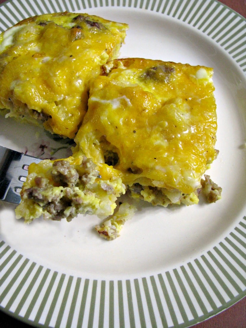 Plated cheesy Sausage Hashbrown Breakfast Casserole, made with frozen hashbrowns, bulk pork sausage, and your favorite cheese, is perfect for Christmas morning or Sunday brunch.