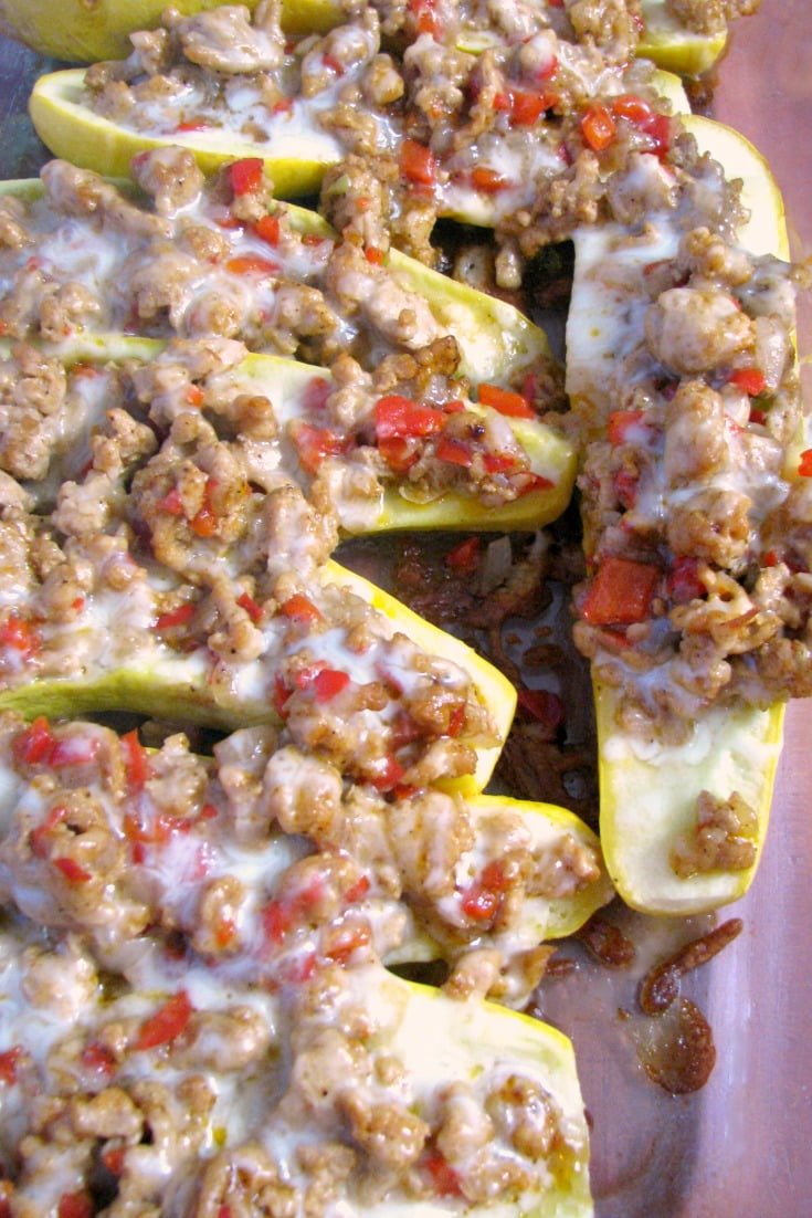 Baked ground Chicken Fajita Stuffed Summer Squash in baking pan overhead photo.