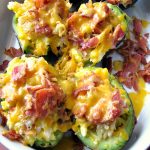 Photo of baked Breakfast Stuffed Avocados in a white baking dish