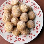 Photo of a plate of Chinese Sugar Donuts on a white and red plate