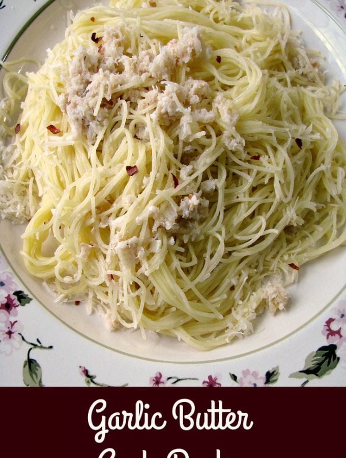 Photo of Garlic Butter Crab Pasta on a white plate with the title written at the bottom