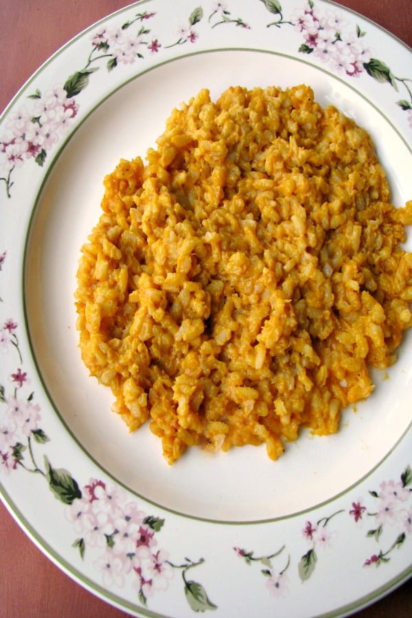 Photo of plated Creamy Pumpkin Risotto on a white plate with flowered trim 