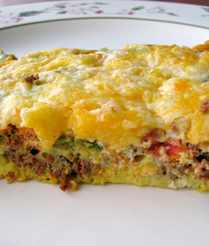 Close up photo of a slice of Mexican Chorizo Breakfast Casserole on a white plate