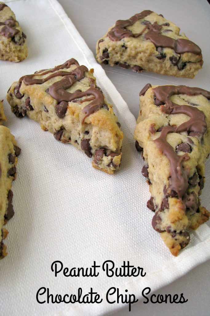 Photo of Peanut Butter Chocolate Chip Scones on a large white cutting board with a white napkin