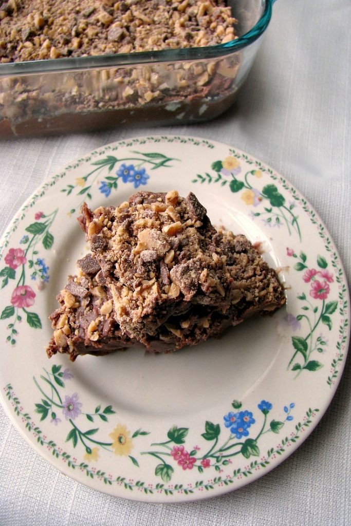 Photo of tow pieces of Milk Chocolate Toffee Fudge on a white flower trimmed plate 