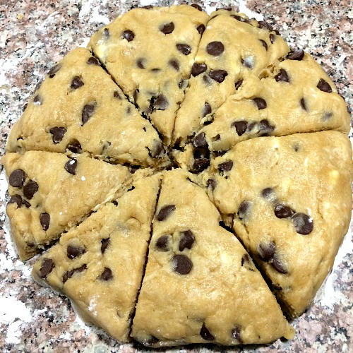 Photo of round dough for Peanut Butter Chocolate Chip Scones cut into almost equal slices