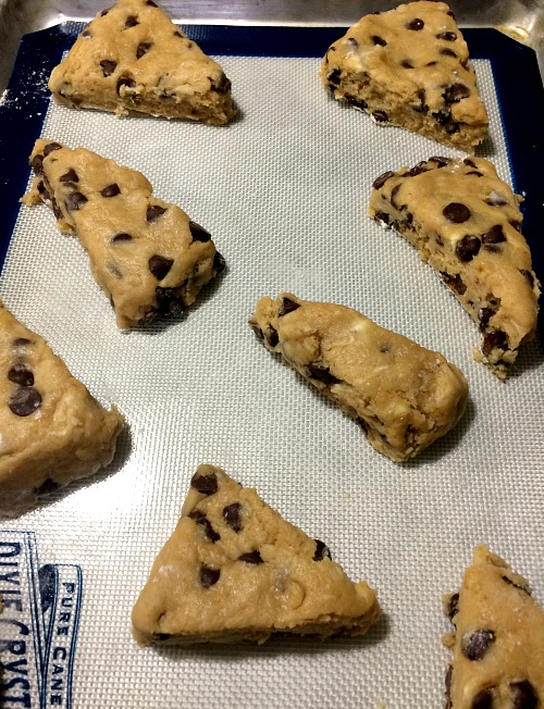 Photo of unbaked scones on a baking sheet lined with a silicone mat