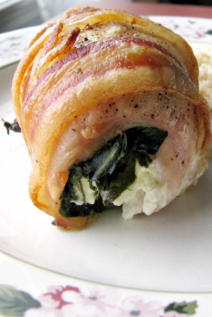 Close up photo of Bacon Wrapped Spinach Cream Cheese stuffed chicken breast.