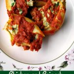 Photo of four Chicken and Spinach Stuffed Shells on a white plate with flower trim