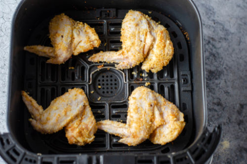 uncooked wings in an air fryer