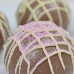 photo of hot chocolate bombs decorated with glitter and melted colored chocolate